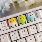 Three colorful budgerigar keycaps fitted on a white keyboard | SIMPOCUBIC