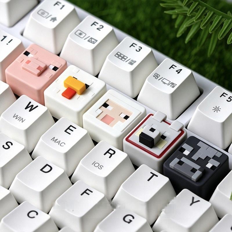 Wide view of Minecraft animal single keycaps on a white keyboard