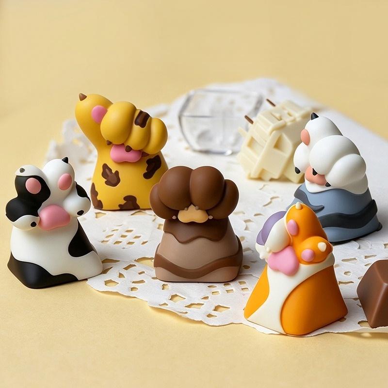 Whose Paw animal single keycaps displayed together on a tabletop